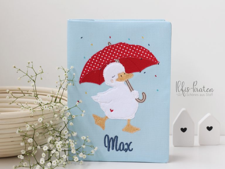 Gesundheitsheft Hülle Schweiz-Ente mit rotem Regenschirm im Konfettiregen