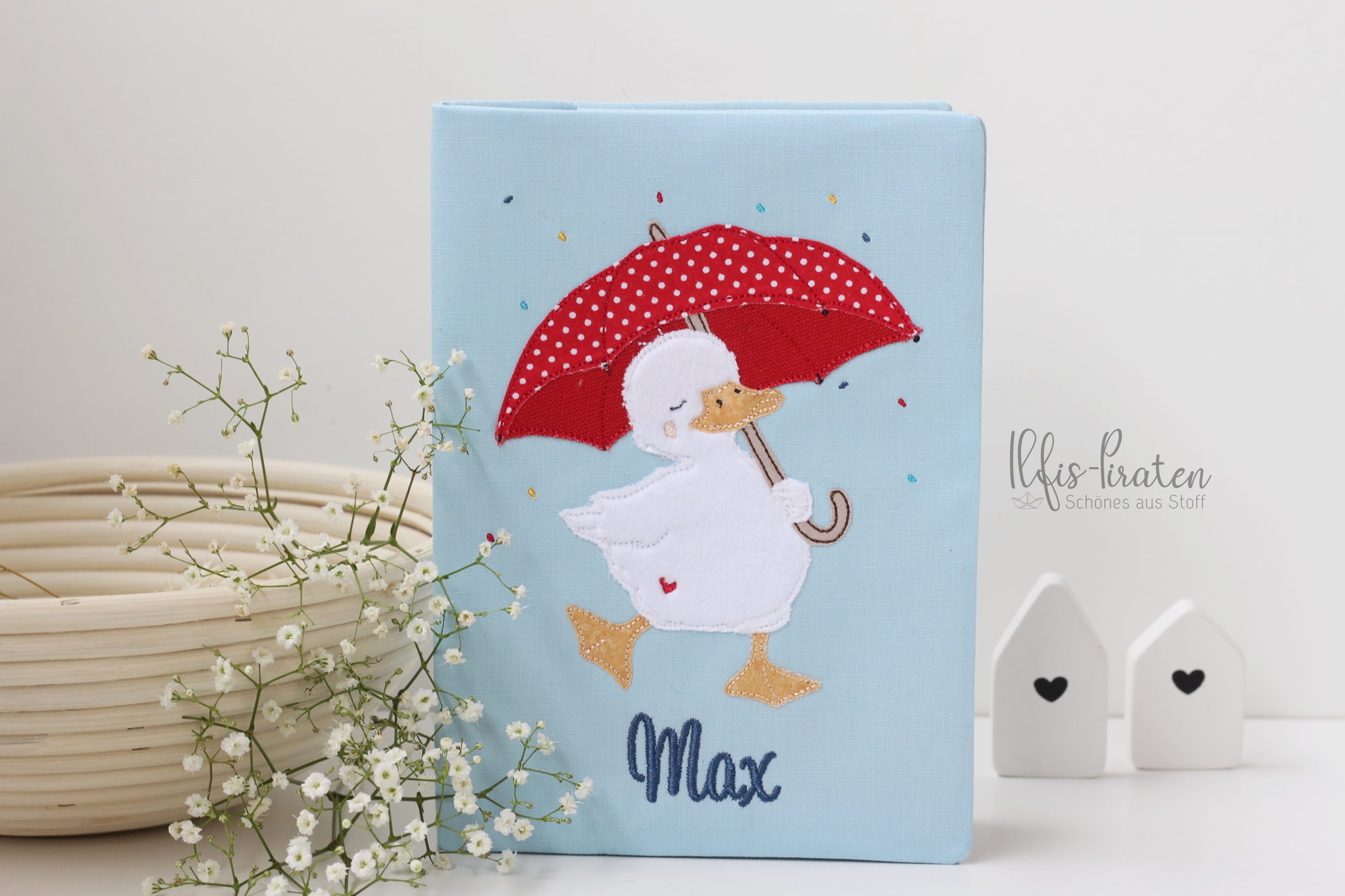 Gesundheitsheft Hülle Schweiz: tanzende Ente mit grossem roten Regenschirm im Konfettiregen