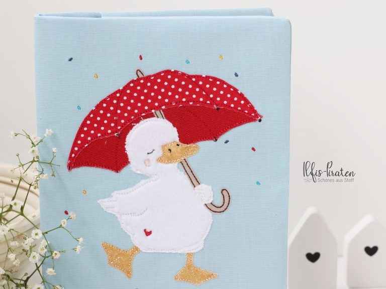 Gesundheitsheft Hülle Schweiz-Ente mit rotem Regenschirm im Konfettiregen